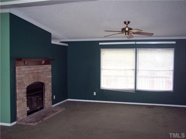 419 Falcon Run Middlesex, NC 27557 - Photo 10 of 24 Large living room FP is double sided with a view from the family room too.