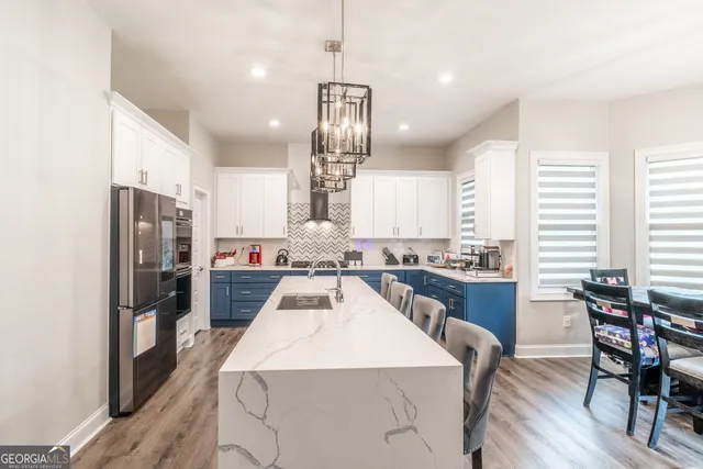 a large kitchen with a table and chairs