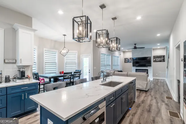a large kitchen with a table and chairs