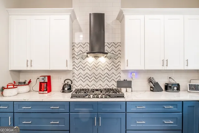 a view of staircase with a floor to ceiling window and a kitchen view