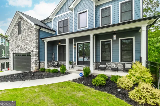 front view of a brick house with a large window and a yard