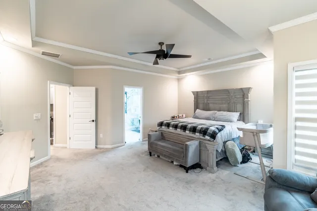 a living room with furniture and a ceiling fan