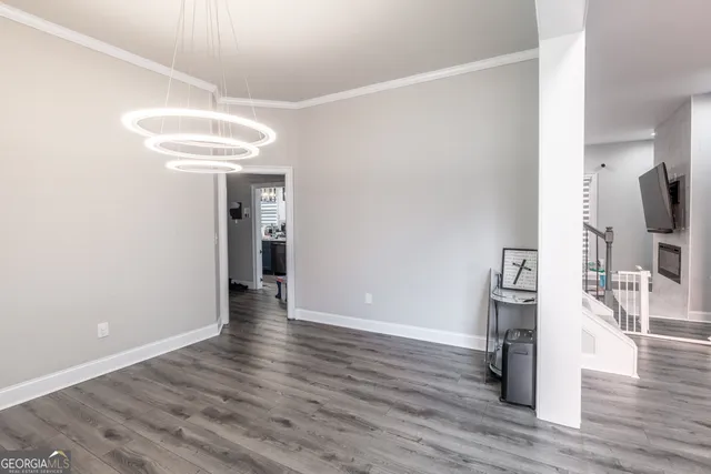 a view of a livingroom with wooden floor and a window
