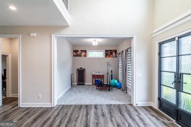 a view of entryway and hall with wooden floor