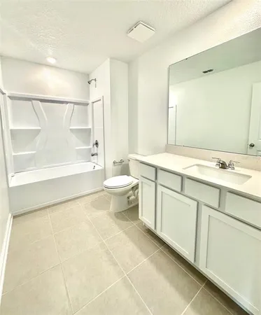 a spacious bathroom with a bathtub sink mirror and toilet
