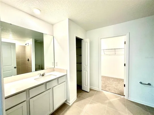 a spacious bathroom with a double vanity sink and a mirror