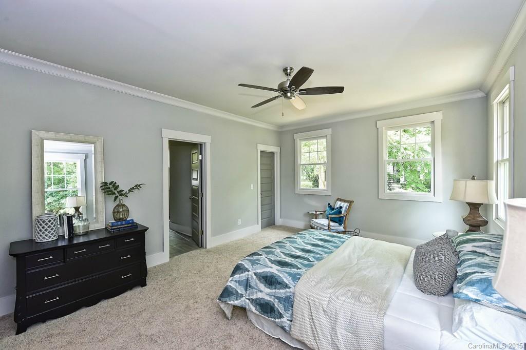 913 Sedgefield Road Charlotte, NC 28209 - Photo 11 of 24 a bedroom with a bed windows and a chandelier