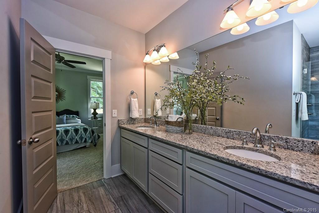 913 Sedgefield Road Charlotte, NC 28209 - Photo 12 of 24 a bathroom with a granite countertop sink a toilet and a mirror