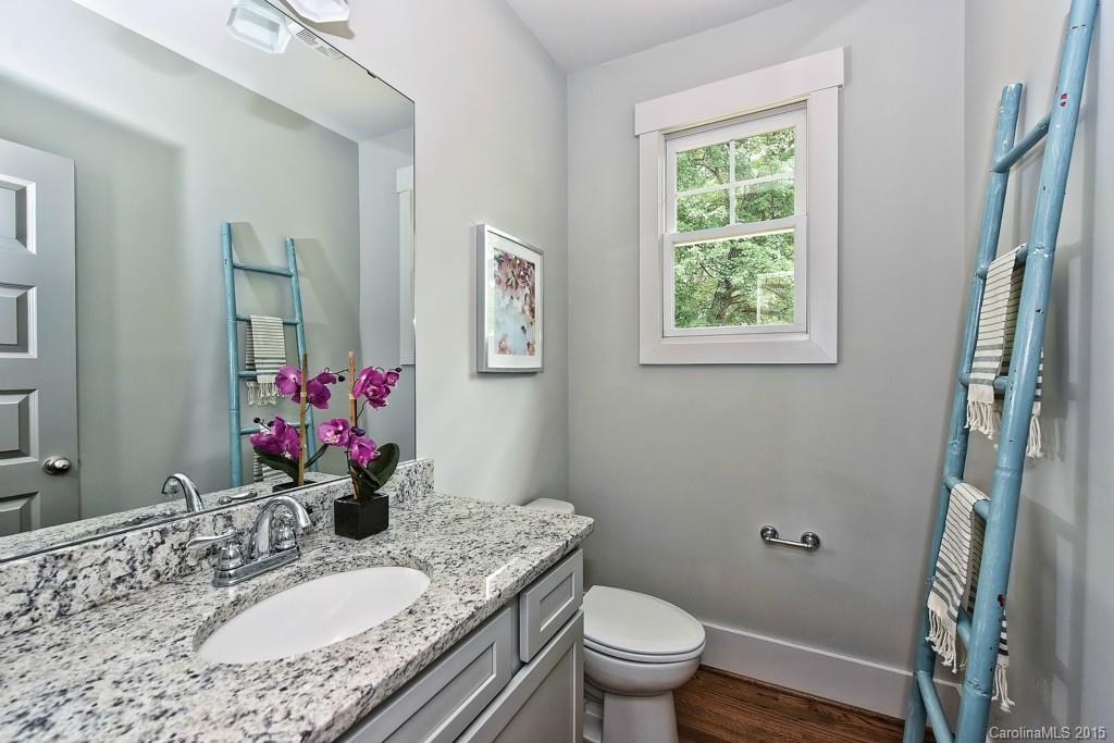 913 Sedgefield Road Charlotte, NC 28209 - Photo 14 of 24 a bathroom with a granite countertop sink toilet and a mirror