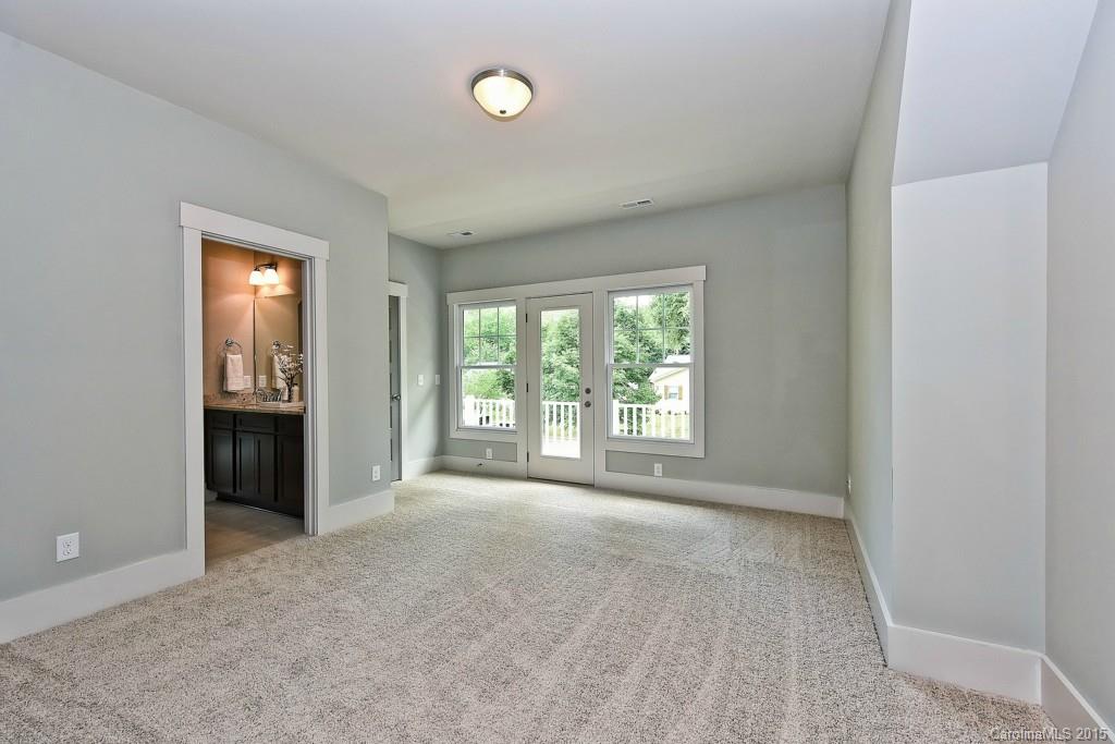 913 Sedgefield Road Charlotte, NC 28209 - Photo 17 of 24 a view of an empty room with a window and a kitchen
