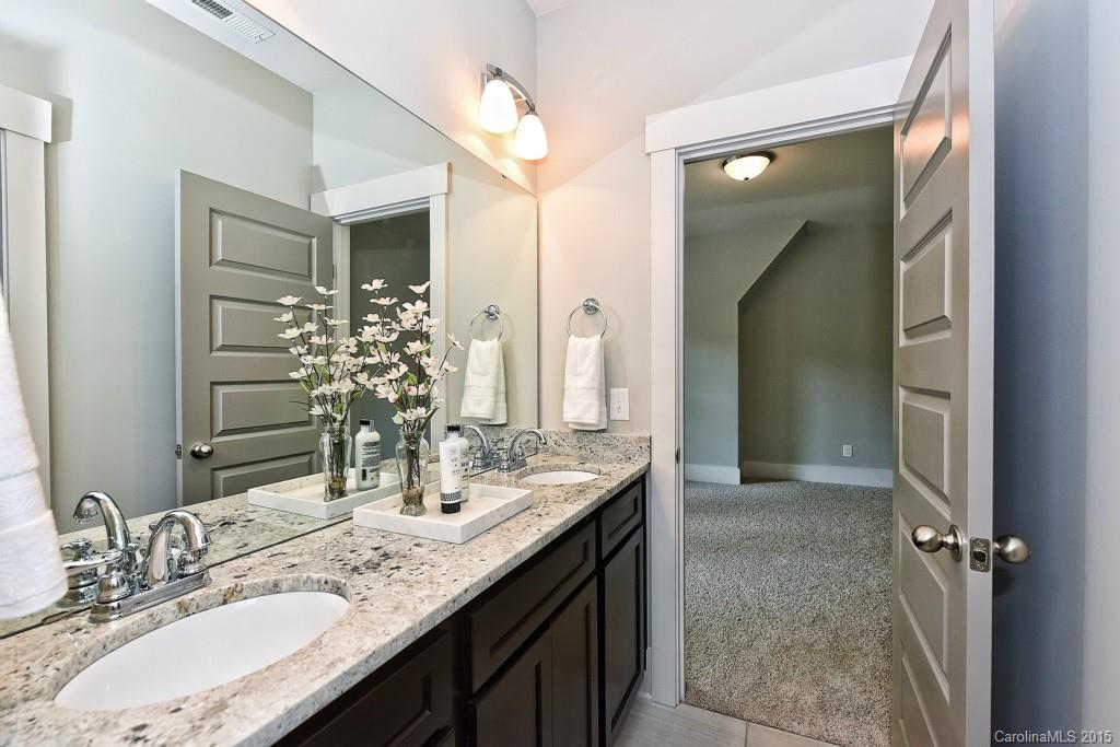 913 Sedgefield Road Charlotte, NC 28209 - Photo 19 of 24 a bathroom with a granite countertop sink and a mirror