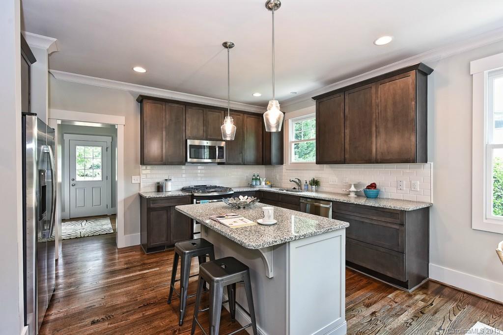 913 Sedgefield Road Charlotte, NC 28209 - Photo 5 of 24 a kitchen with granite countertop a sink a counter space appliances and cabinets