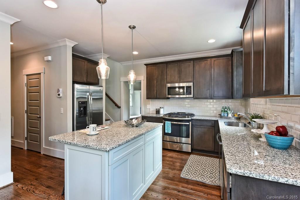 913 Sedgefield Road Charlotte, NC 28209 - Photo 6 of 24 a kitchen with granite countertop stainless steel appliances a stove sink microwave and cabinets