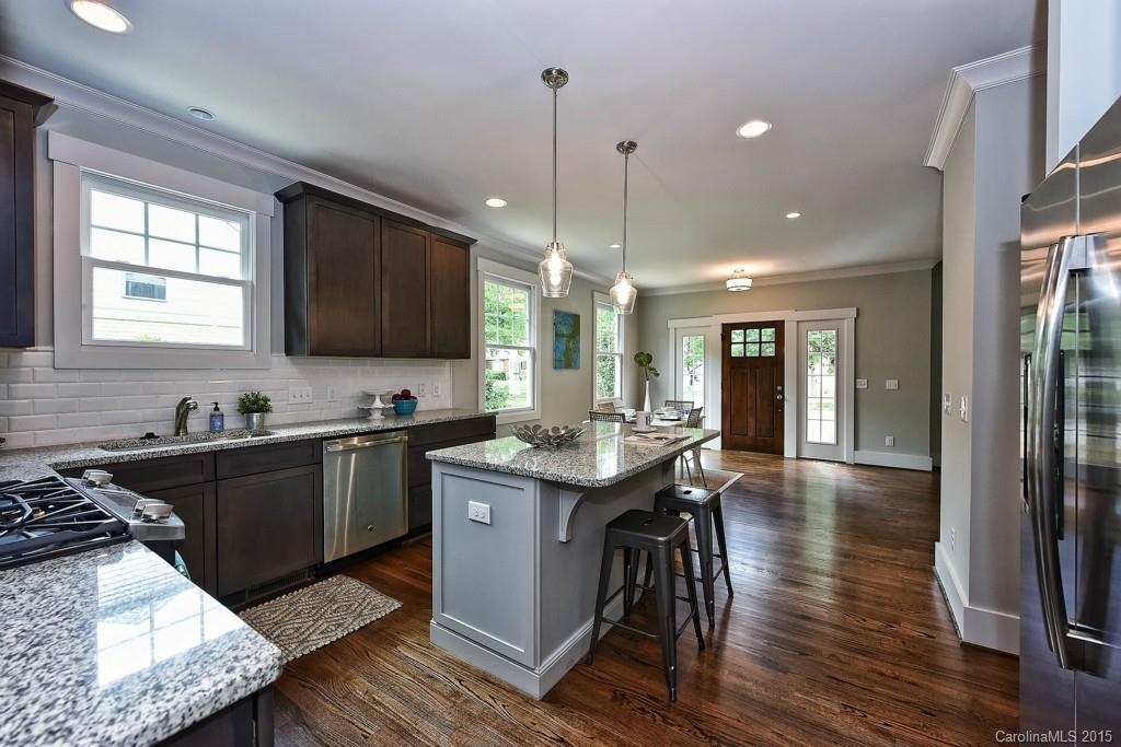 913 Sedgefield Road Charlotte, NC 28209 - Photo 7 of 24 a kitchen with stainless steel appliances granite countertop a sink stove and wooden floor