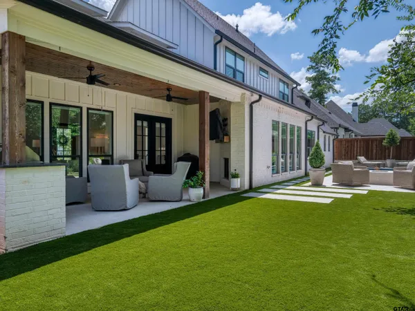a view of a house with swimming pool and porch with furniture