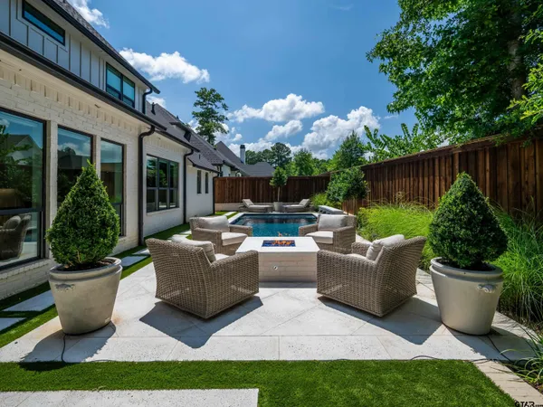 a view of a patio with couches and potted plants