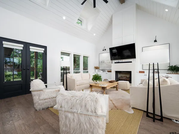 a living room with fireplace furniture and a flat screen tv