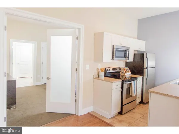 a kitchen with a stove and a refrigerator