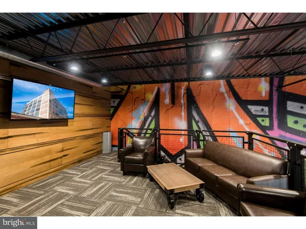 a living room with furniture a flat screen tv and a window