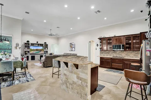 a kitchen with stainless steel appliances kitchen island granite countertop a stove and cabinets
