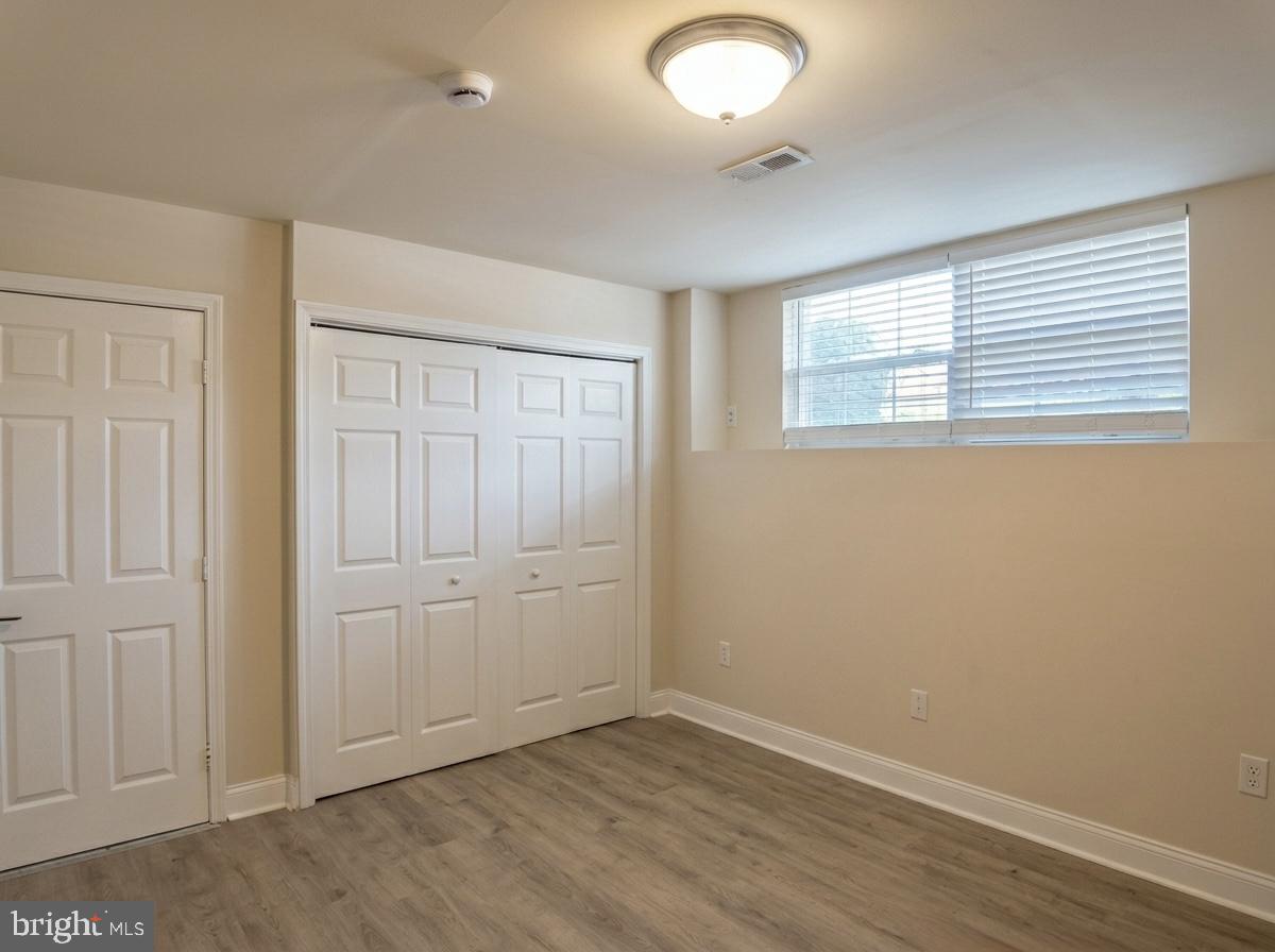 3614 Fawn Spring Court Baltimore, MD 21234 - Photo 6 of 22 an empty room with wooden floor and windows