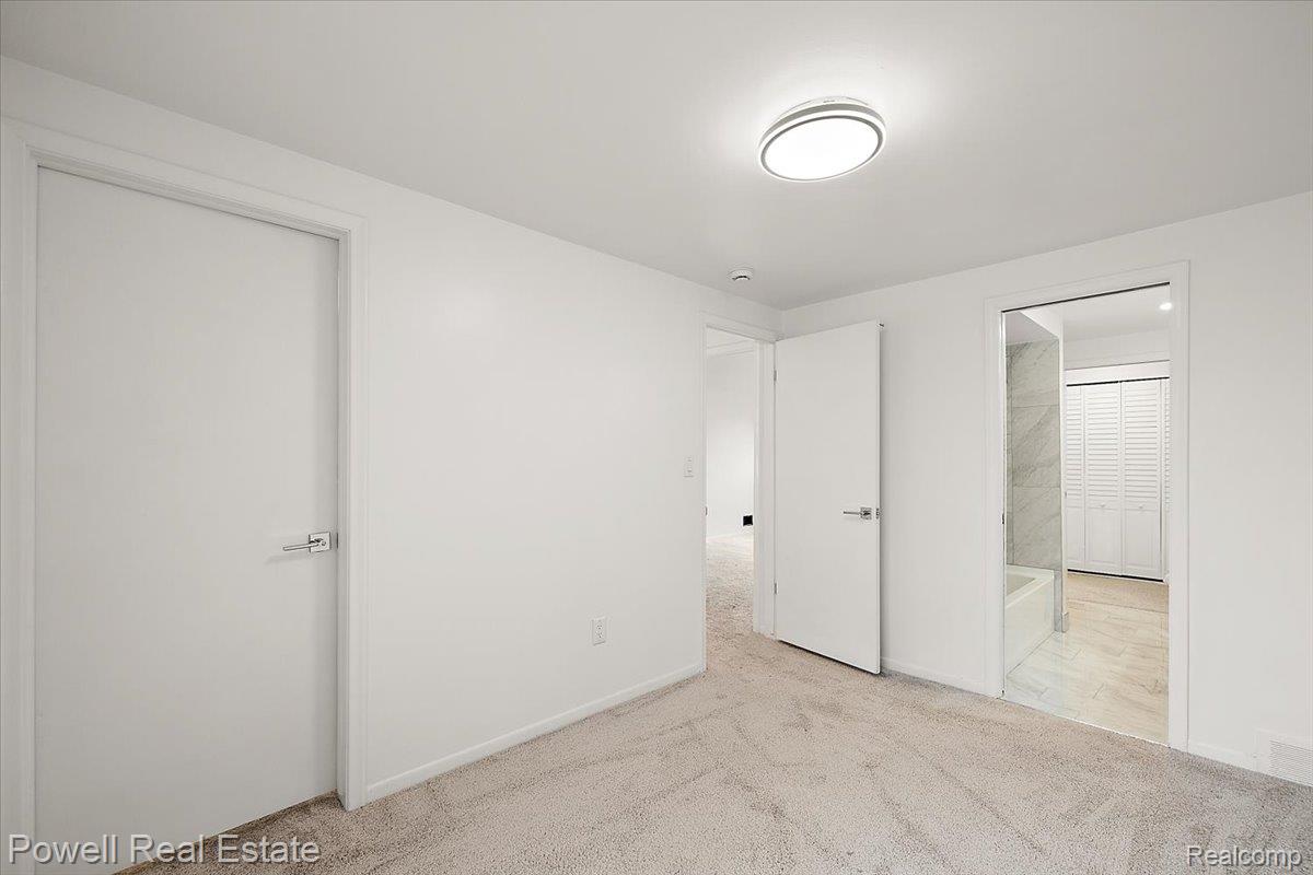 3403 Crooks Road Royal Oak, MI 48073 - Photo 27 of 29 Unfurnished bedroom featuring light carpet and ensuite bath
