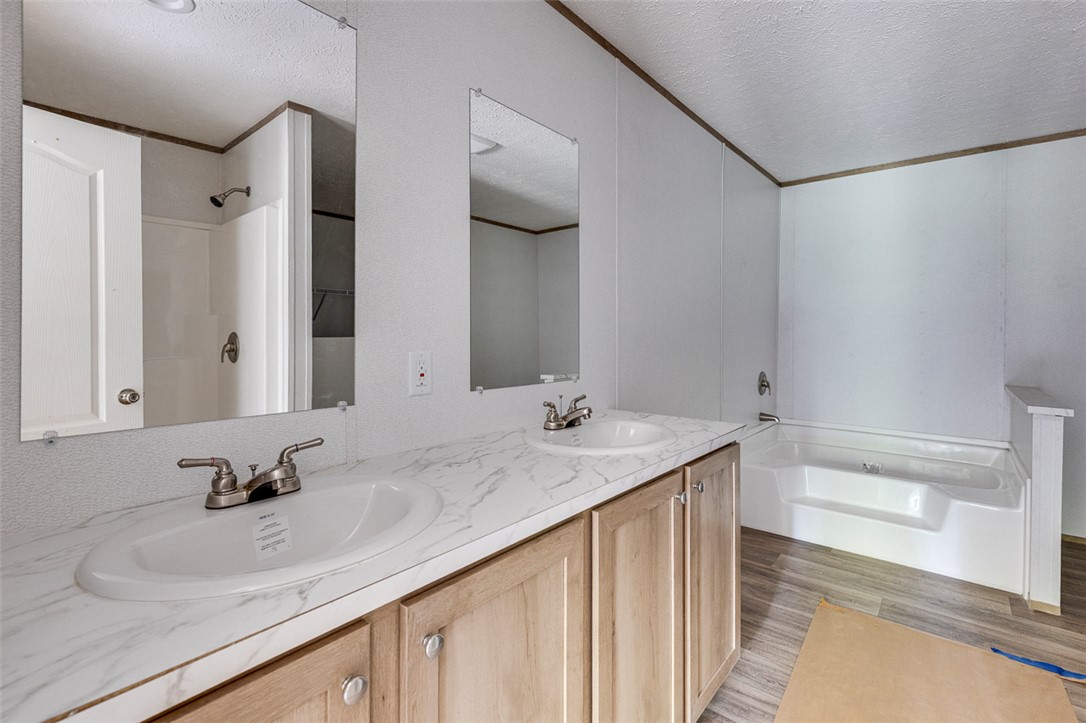 474 Bryant Road Pelzer, SC 29669 - Photo 22 of 42 Double vanity and a soaking tub create a private, functional bathroom.