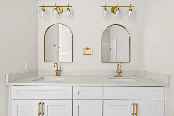 a bathroom with a double vanity sink and a