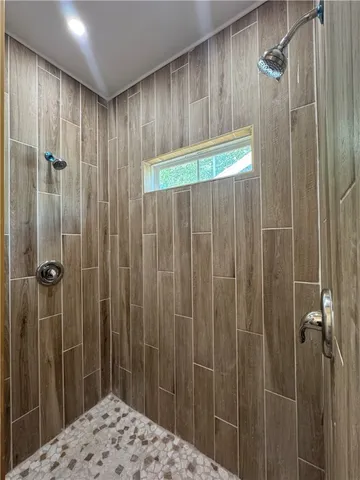 a bathroom with a shower and a sink