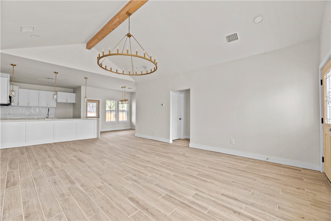947 Mesquite Street Robstown, TX 78380 - Photo 2 of 16 a view of an empty room with a window and kitchen view