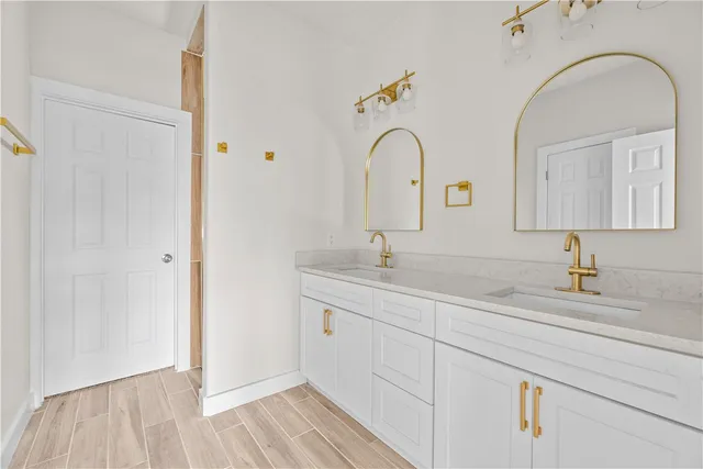 a bathroom with a double vanity sink and a mirror