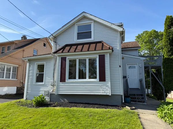 a view of a house with a small yard and a large window