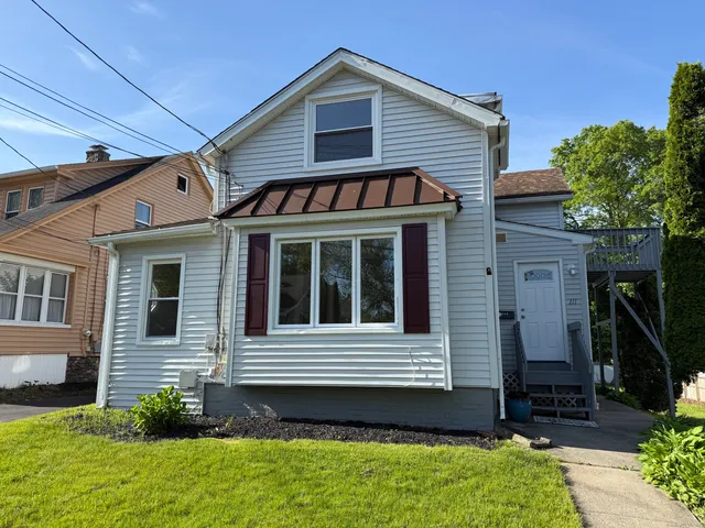 a view of a house with a small yard and a large window