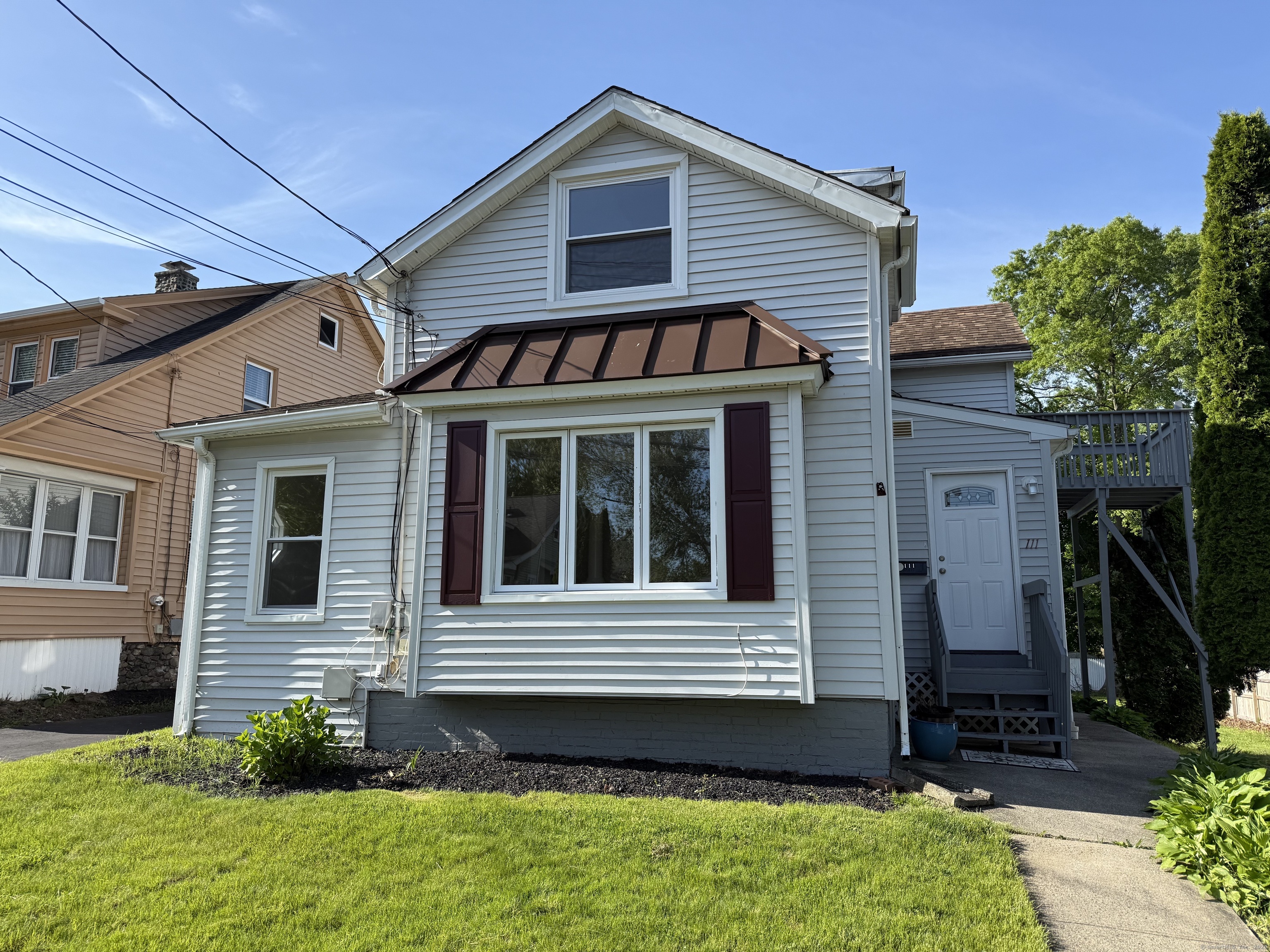 a view of a house with a small yard and a large window