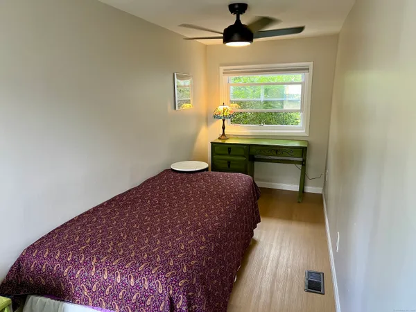 a bedroom with a bed and a window