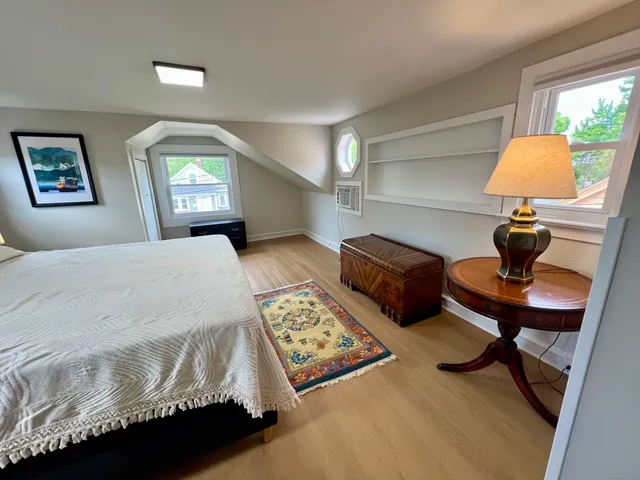 a bedroom with a bed and a lamp