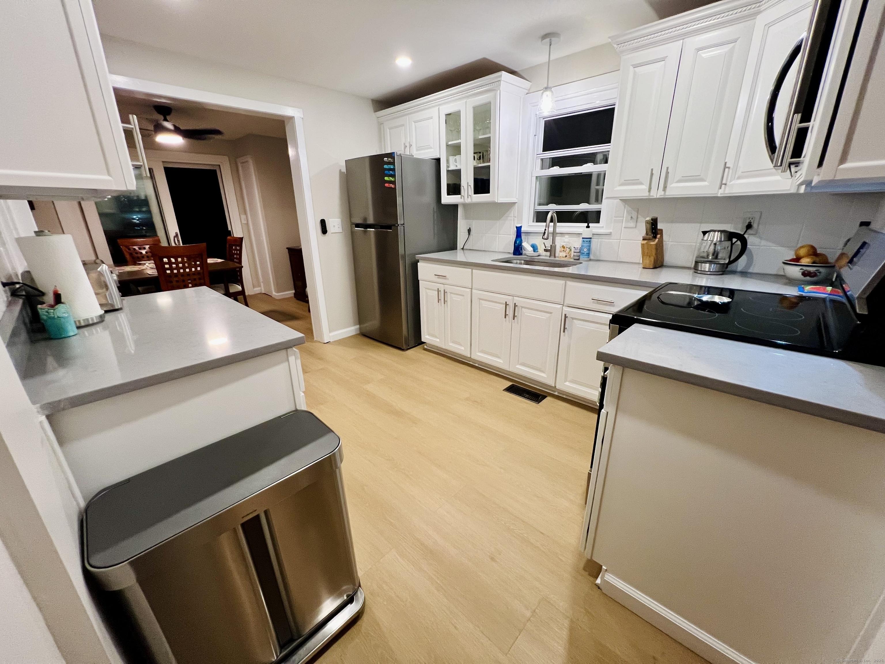 111 Fort Hale Road New Haven, CT 06512 - Photo 7 of 21 a kitchen with stainless steel appliances a stove refrigerator sink and cabinets