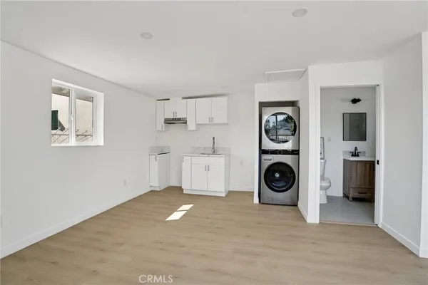 a white bath tub sitting next to a white sink and vanity