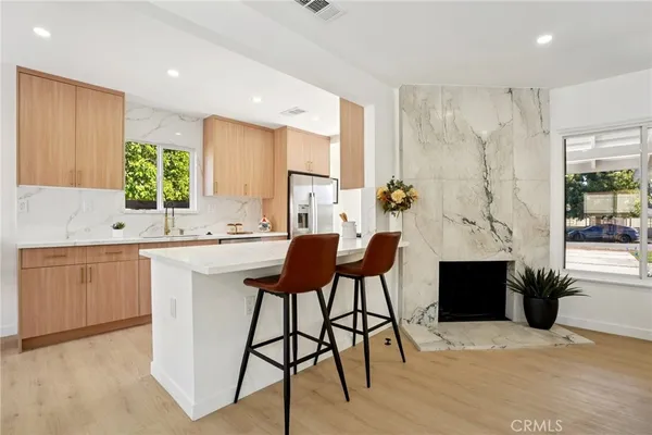 a kitchen with a table chairs sink and cabinets