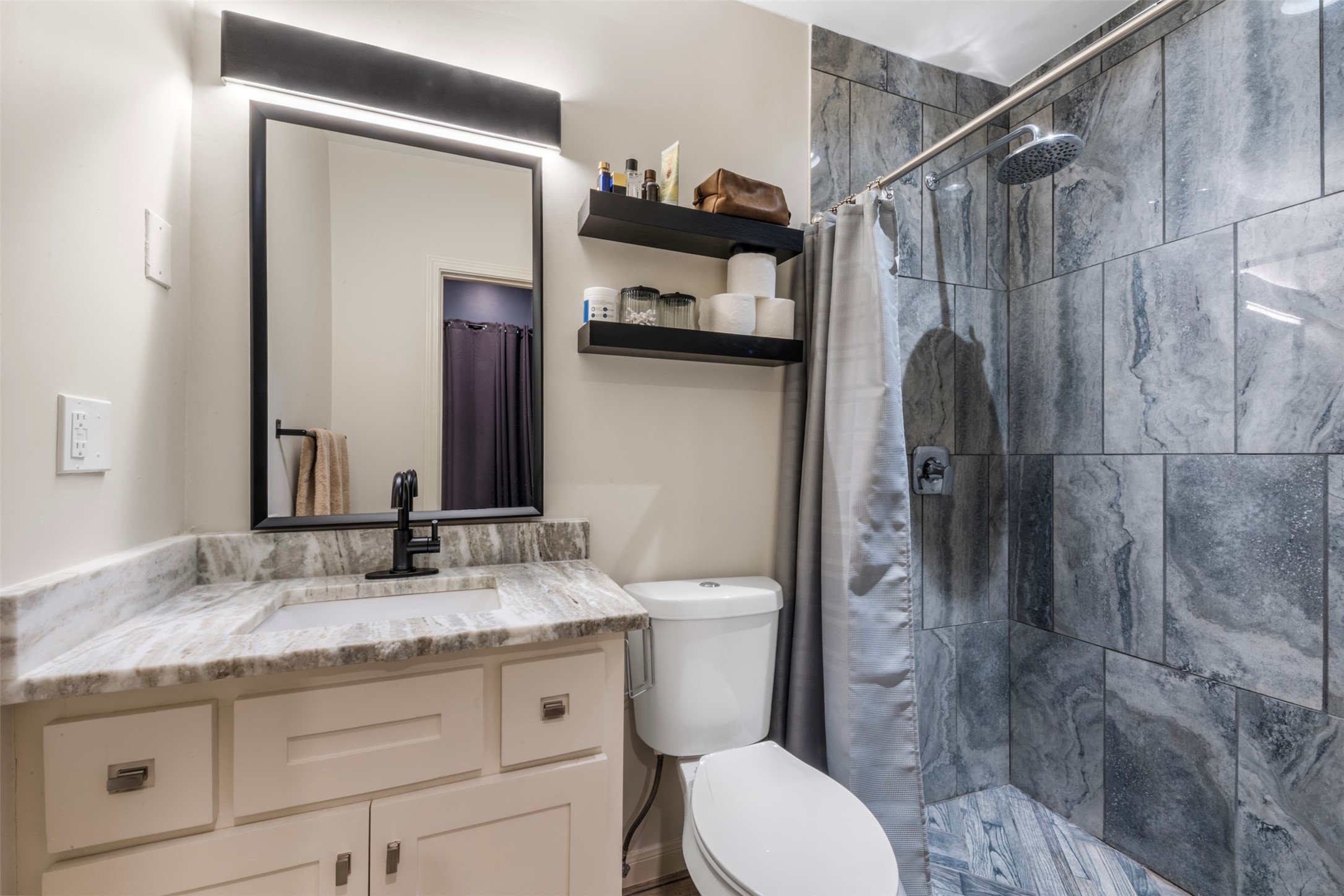 1913 Thonig Road Houston, TX 77055 - Photo 25 of 36 a bathroom with a granite countertop sink toilet and shower