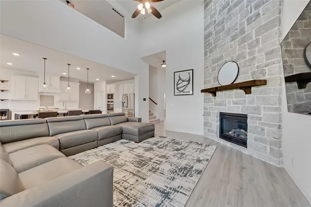 a living room with furniture a flat screen tv and a fireplace