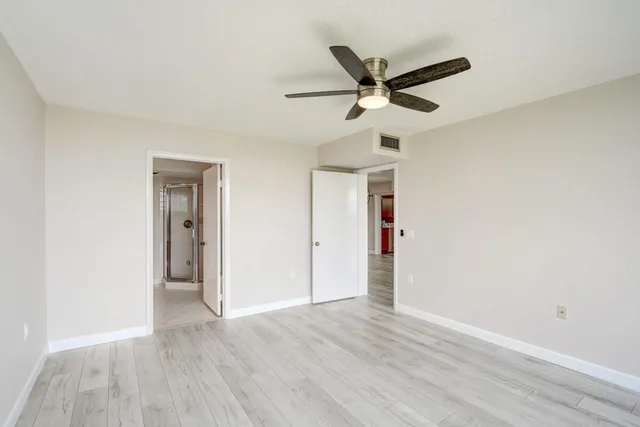 a view of a livingroom with a ceiling fan and wooden floor