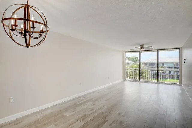 an empty room with wooden floor and sliding door