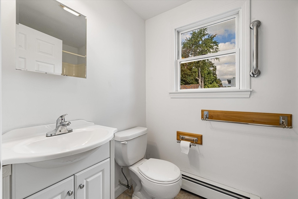 54 Ellsworth Avenue Springfield, MA 01118 - Photo 11 of 29 a bathroom with a sink mirror and toilet