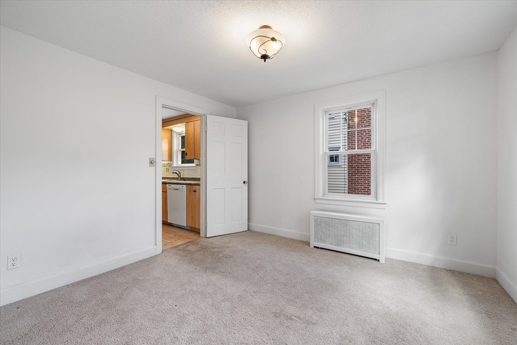 54 Ellsworth Avenue Springfield, MA 01118 - Photo 13 of 29 an empty room with windows and cabinet
