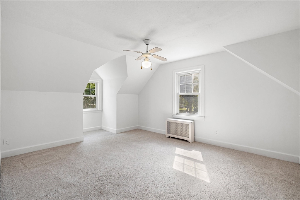 54 Ellsworth Avenue Springfield, MA 01118 - Photo 19 of 29 an empty room with windows and ceiling fan