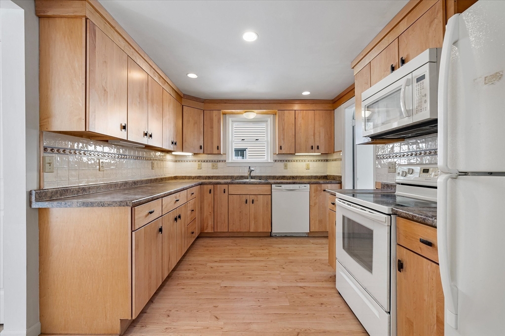 54 Ellsworth Avenue Springfield, MA 01118 - Photo 6 of 29 a kitchen with stainless steel appliances granite countertop a stove sink and cabinets