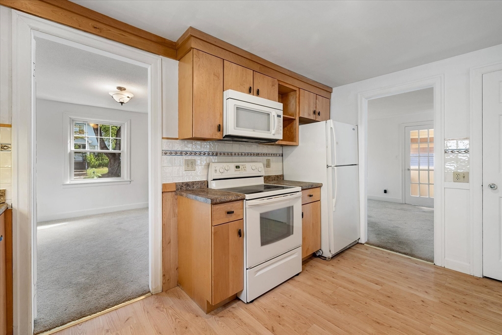 54 Ellsworth Avenue Springfield, MA 01118 - Photo 7 of 29 a kitchen with a stove microwave and refrigerator