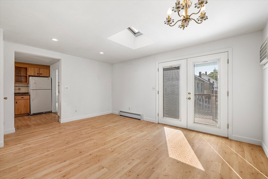 54 Ellsworth Avenue Springfield, MA 01118 - Photo 8 of 29 wooden floor in an empty room with a window