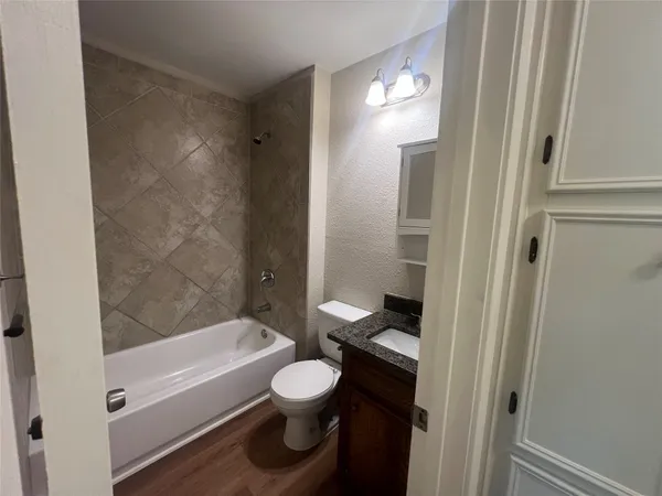 a bathroom with a toilet and a bathtub